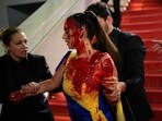 Security escorted the protestor out of the red carpet steps. Security escorted the protestor out of the red carpet steps.