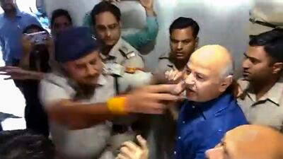 A videograb of police officers with former deputy CM Manish Sisodia at Rouse Avenue court on Tuesday. (PTI) A videograb of police officers with former deputy CM Manish Sisodia at Rouse Avenue court on Tuesday. (PTI)