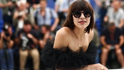 Jury member, for Cannes Film Festival, Ana Lily Amirpour posed for the paparazzi. She was seen in an off-shoulder black dress. Ana also wore dark sunglasses. (REUTERS) 