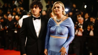 Louane Emera and Florian Rossi posed on the red carpet at the 76th Cannes Film Festival ahead of The Idol's screening. While Louane opted for a blue outfit, Florian was seen in a black tuxedo. (REUTERS) 