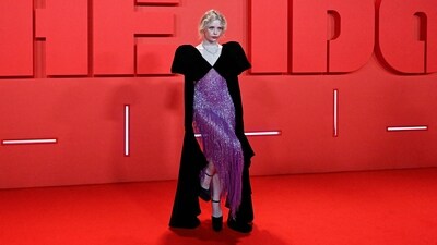 Suzanna Son chose an embellished black and purple look for the occasion. High heels, exaggerated sleeves, a statement neckpiece, and ruby-red lips rounded it off. (AFP) Suzanna Son chose an embellished black and purple look for the occasion. High heels, exaggerated sleeves, a statement neckpiece, and ruby-red lips rounded it off. (AFP)