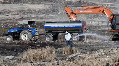 Fire officials believe that the blaze at the vacant plot in Sector 32 in Noida was reignited by the wind. (Sunil Ghosh/HT Photo) Fire officials believe that the blaze at the vacant plot in Sector 32 in Noida was reignited by the wind. (Sunil Ghosh/HT Photo)
