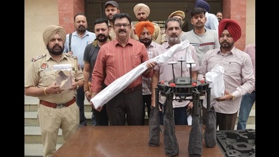 Special Task Force (STF) of Punjab Police officials showing the seized drone, weapons and 1.6 kg of heroin, on Tuesday. (Sameer Sehgal /HT) Special Task Force (STF) of Punjab Police officials showing the seized drone, weapons and 1.6 kg of heroin, on Tuesday. (Sameer Sehgal /HT)