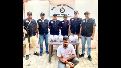 The accused in the custody of special task force officers.