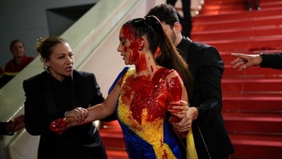 Security escorted the protestor out of the red carpet steps. Security escorted the protestor out of the red carpet steps.