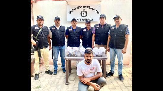 The accused in the custody of special task force officers.