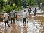 People wade through a waterlogged road after a rain shower in Bengaluru. (AFP/Image for representation) People wade through a waterlogged road after a rain shower in Bengaluru. (AFP/Image for representation)