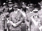 File image of King Victor Emanuel III, Adolf Hitler and Benito Mussolini watch fascist troops march in central Rome in 1941 television file footage. Image via REUTERS