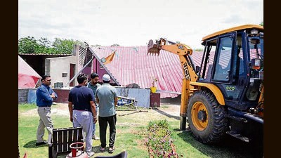 A team from the Panchkula district town planner office demolishing an illegal dhaba in Baad village, Kalka, on Wednesday. (HT Photo)