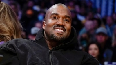 FILE - Kanye West, known as Ye, watches the first half of an NBA basketball game between the Washington Wizards and the Los Angeles Lakers in Los Angeles, March 11, 2022. Adidas saw operating earnings dwindle in the first three months of the year as the German sportswear company's breakup with the rapper formerly known as Kanye West and his popular Yeezy shoe brand cost it 400 million euros ($441 million) in lost sales. Profit was down to 60 million euros from 437 million euros in the same quarter a year ago, while profit margin shrank to a bare 1.1%. Net sales declined 1%, to 5.27 billion euros, and would have risen 9% with the Yeezy line, the company said Friday, May 5, 2023. (AP Photo/Ashley Landis, File) (AP) FILE - Kanye West, known as Ye, watches the first half of an NBA basketball game between the Washington Wizards and the Los Angeles Lakers in Los Angeles, March 11, 2022. Adidas saw operating earnings dwindle in the first three months of the year as the German sportswear company's breakup with the rapper formerly known as Kanye West and his popular Yeezy shoe brand cost it 400 million euros ($441 million) in lost sales. Profit was down to 60 million euros from 437 million euros in the same quarter a year ago, while profit margin shrank to a bare 1.1%. Net sales declined 1%, to 5.27 billion euros, and would have risen 9% with the Yeezy line, the company said Friday, May 5, 2023. (AP Photo/Ashley Landis, File) (AP)
