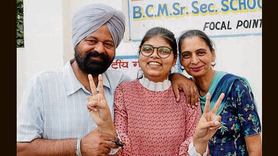 Navpreet Kaur with her parents in Ludhiana on Wednesday. (Manish/HT) Navpreet Kaur with her parents in Ludhiana on Wednesday. (Manish/HT)