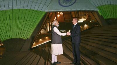 Prime Minister Narendra Modi and Australian PM Anthony Albanese in front of the sails of the Sydney Opera House illuminated in the colours of the Indian flag in Sydney. (AP) Prime Minister Narendra Modi and Australian PM Anthony Albanese in front of the sails of the Sydney Opera House illuminated in the colours of the Indian flag in Sydney. (AP)