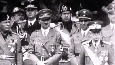 File image of King Victor Emanuel III, Adolf Hitler and Benito Mussolini watch fascist troops march in central Rome in 1941 television file footage. Image via REUTERS (Reuters)