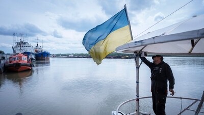 FILE - A sailor fixes the flag of Ukraine on a boat in Izmail, 700 km (432 miles) southwest of Kiev, Ukraine, on April 26, 2023. The United Nations is racing to extend a deal that has allowed for shipments of Ukrainian grain through the Black Sea to parts of the world struggling with hunger, helping ease a global food crisis exacerbated by the war that Russia launched more than a year ago.(AP Photo/Andrew Kravchenko, File) (AP) FILE - A sailor fixes the flag of Ukraine on a boat in Izmail, 700 km (432 miles) southwest of Kiev, Ukraine, on April 26, 2023. The United Nations is racing to extend a deal that has allowed for shipments of Ukrainian grain through the Black Sea to parts of the world struggling with hunger, helping ease a global food crisis exacerbated by the war that Russia launched more than a year ago.(AP Photo/Andrew Kravchenko, File) (AP)
