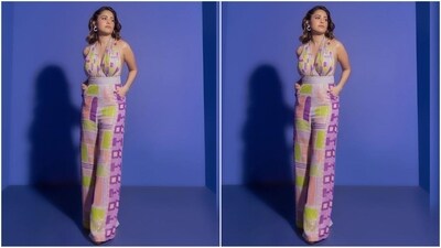 In the post, the actress mesmerises in a breathtaking jumpsuit from the fashion brand Nirmooha. The ensemble boasts a plunging neckline, a halter neck with a back tie-up, and a quirky multi colour lurex geometric print that covers the entire outfit. (Instagram/@nushrrattbharuccha) In the post, the actress mesmerises in a breathtaking jumpsuit from the fashion brand Nirmooha. The ensemble boasts a plunging neckline, a halter neck with a back tie-up, and a quirky multi colour lurex geometric print that covers the entire outfit. (Instagram/@nushrrattbharuccha)