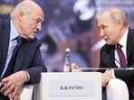 Russian President Vladimir Putin, right, and Belarusian President Alexander Lukashenko talk to each other during the plenary session of the Eurasian Economic Forum in Moscow, Russia.