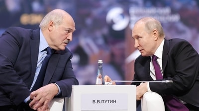 Russian President Vladimir Putin, right, and Belarusian President Alexander Lukashenko talk to each other during the plenary session of the Eurasian Economic Forum in Moscow, Russia. (AP) Russian President Vladimir Putin, right, and Belarusian President Alexander Lukashenko talk to each other during the plenary session of the Eurasian Economic Forum in Moscow, Russia. (AP)