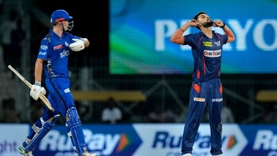 Mumbai Indians batter Cameron Green walks back to the pavilion after his dismissal as Lucknow Super Giants bowler Naveen-ul-Haq celebrates (PTI) Mumbai Indians batter Cameron Green walks back to the pavilion after his dismissal as Lucknow Super Giants bowler Naveen-ul-Haq celebrates (PTI)