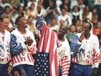 US basketball player Michael Jordan flashes a victory sign as he stands with team mates after winning the Olympic gold in Barcelona, Spain on August 8, 1992. 