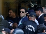Security officers escort Pakistan's former Prime Minister Imran Khan, as he appeared in Islamabad High Court, Islamabad, Pakistan.