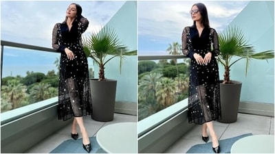 Another photoshoot of Manushi showed the actor chilling on the balcony in a statement-making black netted dress featuring a collared neckline, colourful gem embellishments, full-length sleeves, and a sleek silhouette complementing her svelte frame. (Instagram) Another photoshoot of Manushi showed the actor chilling on the balcony in a statement-making black netted dress featuring a collared neckline, colourful gem embellishments, full-length sleeves, and a sleek silhouette complementing her svelte frame. (Instagram)
