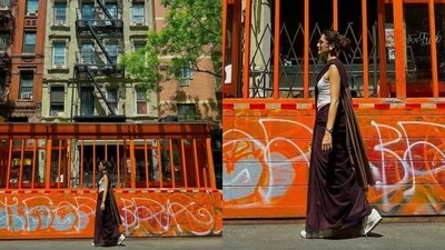 Taapsee Pannu wore a purple and brownish saree for a stroll around New York during her vacation with boyfriend and her sister. She paired her saree with white top and white sneakers. Taapsee Pannu wore a purple and brownish saree for a stroll around New York during her vacation with boyfriend and her sister. She paired her saree with white top and white sneakers.