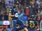 Gujarat Titans' Shubman Gill (R) celebrates after scoring a century (100 runs) during the Indian Premier League (IPL) Twenty20 second qualifier cricket match between Mumbai Indians and Gujarat Titans at the Narendra Modi Stadium in Ahmedabad on May 26, 2023. (Photo by Sajjad HUSSAIN / AFP)