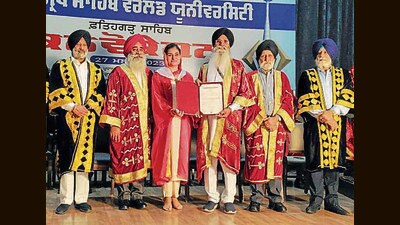 A student getting her degree during the convocation at Sri Guru Granth Sahib World University in Patiala on Saturday. (HT Photo)