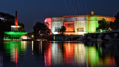 The new parliament building illuminated in tri-color ahead of its inauguration ceremony, in New Delhi. (ANI) The new parliament building illuminated in tri-color ahead of its inauguration ceremony, in New Delhi. (ANI)