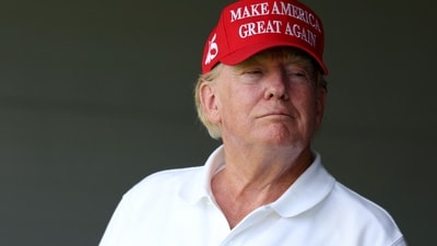 STERLING, VIRGINIA - MAY 26: Former US President Donald Trump watches from a box on the 18th green during day one of the LIV Golf Invitational - DC at Trump National Golf Club on May 26, 2023 in Sterling, Virginia. Rob Carr/Getty Images/AFP (Photo by Rob Carr / GETTY IMAGES NORTH AMERICA / Getty Images via AFP) (Getty Images via AFP) STERLING, VIRGINIA - MAY 26: Former US President Donald Trump watches from a box on the 18th green during day one of the LIV Golf Invitational - DC at Trump National Golf Club on May 26, 2023 in Sterling, Virginia. Rob Carr/Getty Images/AFP (Photo by Rob Carr / GETTY IMAGES NORTH AMERICA / Getty Images via AFP) (Getty Images via AFP)