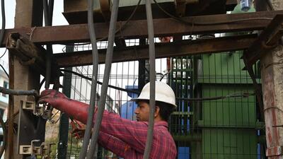 Gurugram, India-May 25 : A DHBVN worker repairing the damaged wire due to overload on a hot summer day at 4/8 Marla Near Government School, in Gurugram, India, on Thursday, 25 May 2023. (Photo by Parveen Kumar/Hindustan Times)(Pic to go with Leena Dhankar's story)