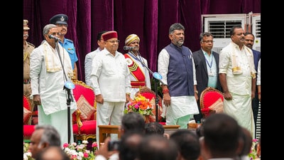 Karnataka Governor Thaawarchand Gehlot, chief minister Siddaramaiah and deputy chief minister DK Shivakumar with newly-inducted cabinet ministers during the swearing-in ceremony at Raj Bhavan, in Bengaluru on Saturday. (PTI) Karnataka Governor Thaawarchand Gehlot, chief minister Siddaramaiah and deputy chief minister DK Shivakumar with newly-inducted cabinet ministers during the swearing-in ceremony at Raj Bhavan, in Bengaluru on Saturday. (PTI)