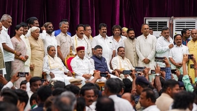 Karnataka Chief Minister Siddaramaiah and Deputy Chief Minister DK Shivakumar with newly-inducted cabinet ministers during the swearing-in ceremony at Raj Bhavan, in Bengaluru on Saturday. (PTI) Karnataka Chief Minister Siddaramaiah and Deputy Chief Minister DK Shivakumar with newly-inducted cabinet ministers during the swearing-in ceremony at Raj Bhavan, in Bengaluru on Saturday. (PTI)