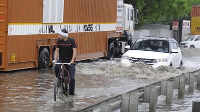 Vehicles wade through a waterlogged stretch in Gurugram on Saturday. (Parveen Kumar/ HT)