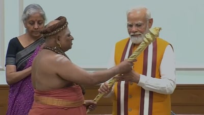 A priest hands over Sengol to Prime Minister Narendra Modi at his official residence. (sourced)