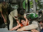 Security personnel detain wrestlers during their protest march towards new Parliament building, in New Delhi, Sunday, May 28, 2023