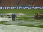 Groundsmen holding umbrellas near the covered pitch as it rains ahead of the IPL 2023 final cricket match between Gujarat Titans and Mumbai Indians Groundsmen holding umbrellas near the covered pitch as it rains ahead of the IPL 2023 final cricket match between Gujarat Titans and Mumbai Indians