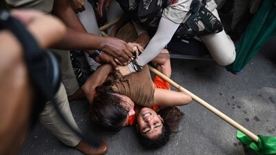 Indian wrestlers Sangeeta Phogat and Vinesh Phogat struggle as they are detained by the police while attempting to march to India's new parliament, just as it was being inaugurated by Prime Minister Narendra Modi. (AFP) Indian wrestlers Sangeeta Phogat and Vinesh Phogat struggle as they are detained by the police while attempting to march to India's new parliament, just as it was being inaugurated by Prime Minister Narendra Modi. (AFP)