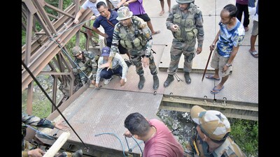 Indian Army jawans repaired the Wainem Bridge after unidentified miscreants damaged and dislocated its three panels. (ANI) Indian Army jawans repaired the Wainem Bridge after unidentified miscreants damaged and dislocated its three panels. (ANI)