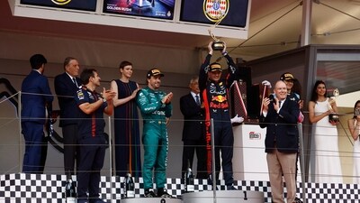 Red Bull's Max Verstappen celebrates on the podium after winning the Monaco Grand Prix as Prince Albert II of Monaco with his wife Princess Charlene applaud (REUTERS)