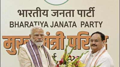Prime Minister Narendra Modi being felicitated by Bharatiya Janata Party national president JP Nadda during the 'Mukhyamantri Parishad' meeting at party headquarters, in New Delhi on Sunday. (BJP)
