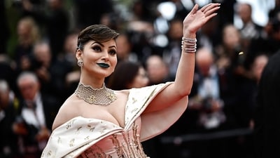 Actor Urvashi Rautela too grabbed attention for her fashion choices at Cannes 2023 -- from her green feature dress to her alligator necklace. As she walked the red carpet at the screening of Indiana Jones and the Dial of Destiny, Urvashi wore a blue and white gown, and accessorised her look with striking blue lips. (AFP) Actor Urvashi Rautela too grabbed attention for her fashion choices at Cannes 2023 -- from her green feature dress to her alligator necklace. As she walked the red carpet at the screening of Indiana Jones and the Dial of Destiny, Urvashi wore a blue and white gown, and accessorised her look with striking blue lips. (AFP)