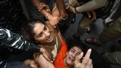 Wrestlers Sangeeta Phogat and Vinesh Phogat being detained during the protest march from Jantar Mantar to New Parliament House. (ANI) Wrestlers Sangeeta Phogat and Vinesh Phogat being detained during the protest march from Jantar Mantar to New Parliament House. (ANI)