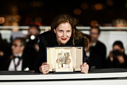 French director Justine Triet poses with her trophy during a photocall after she won the Palme d'Or for the film Anatomie d'une Chute (Anatomy of a Fall) during the closing ceremony of the 76th edition of the Cannes Film Festival. (AFP)