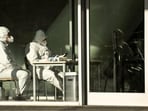 Covid In China: Security guards wearing personal protective equipment (PPE) amid the Covid-19 pandemic sit at an entrance of a building in Beijing.