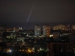 Ukrainian servicemen use a searchlight as they search for drones in the sky over the city during a Russian drone and missile strike. 
