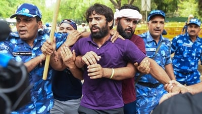 Wrestler Bajrang Punia being stopped during the protest march from Jantar Mantar to new Parliament House. (ANI) Wrestler Bajrang Punia being stopped during the protest march from Jantar Mantar to new Parliament House. (ANI)