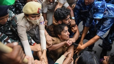 Police and Paramilitary personnel detain wrestler Vinesh Phogat during the protest march from Jantar Mantar to New Parliament House against the alleged sexual harassment of women wrestlers by WFI chief Brij Bhushan Sharan Singh, in New Delhi on Sunday. (ANI Photo/Amit Sharma) (Amit Sharma) Police and Paramilitary personnel detain wrestler Vinesh Phogat during the protest march from Jantar Mantar to New Parliament House against the alleged sexual harassment of women wrestlers by WFI chief Brij Bhushan Sharan Singh, in New Delhi on Sunday. (ANI Photo/Amit Sharma) (Amit Sharma)