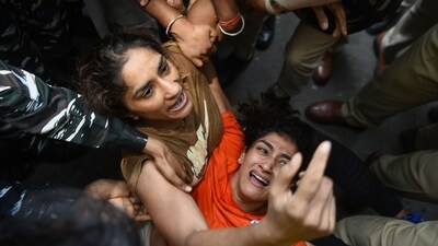 Wrestlers Sangeeta Phogat and Vinesh Phogat being detained during the protest march from Jantar Mantar to New Parliament House against the alleged sexual harassment of women wrestlers by WFI chief Brij Bhushan Sharan Singh, in New Delhi on Sunday (ANI) Wrestlers Sangeeta Phogat and Vinesh Phogat being detained during the protest march from Jantar Mantar to New Parliament House against the alleged sexual harassment of women wrestlers by WFI chief Brij Bhushan Sharan Singh, in New Delhi on Sunday (ANI)