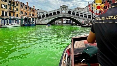 In this image released by the Italian firefighters, a firefighter on a boat looks at the arched Rialto Bridge along Venice's historical Grand Canal as a patch of phosphorescent green liquid spreads in it. (AP) In this image released by the Italian firefighters, a firefighter on a boat looks at the arched Rialto Bridge along Venice's historical Grand Canal as a patch of phosphorescent green liquid spreads in it. (AP)